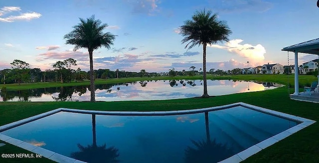 532 Atlantic Beach Ct, Atlantic Beach, FL 32233 - pool at dusk featuring a water view and a yard