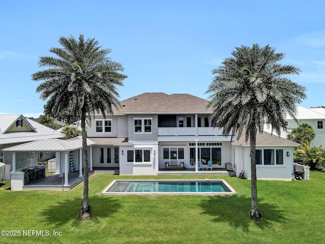 532 Atlantic Beach Ct, Atlantic Beach, FL 32233 - back of property featuring a balcony, stucco siding, an outdoor pool, and a lawn