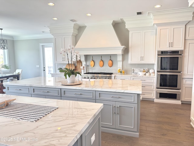 532 Atlantic Beach Ct, Atlantic Beach, FL 32233 - kitchen featuring double oven, gray cabinets, light stone counters, crown molding, and recessed lighting