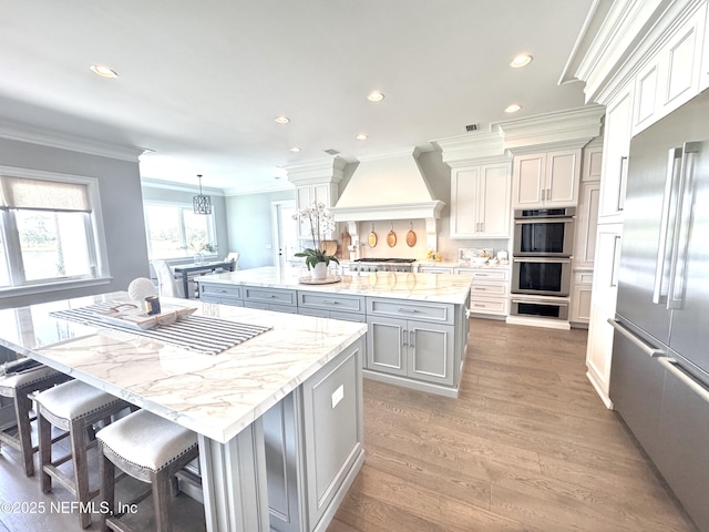 532 Atlantic Beach Ct, Atlantic Beach, FL 32233 - kitchen featuring a center island, premium range hood, stainless steel appliances, crown molding, and recessed lighting