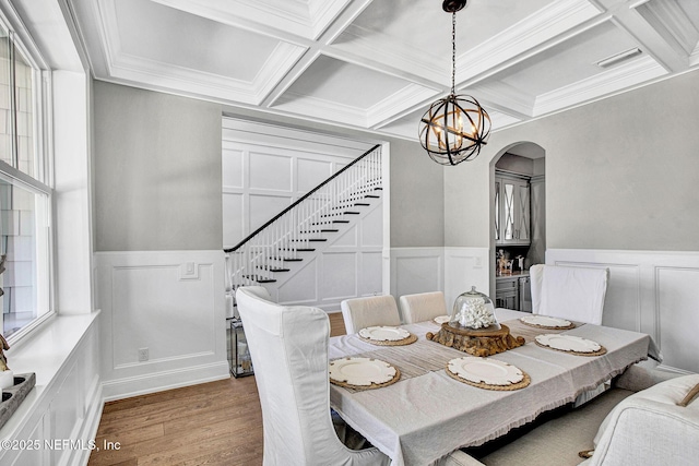 532 Atlantic Beach Ct, Atlantic Beach, FL 32233 - dining area featuring coffered ceiling, a decorative wall, wainscoting, wood finished floors, and a chandelier