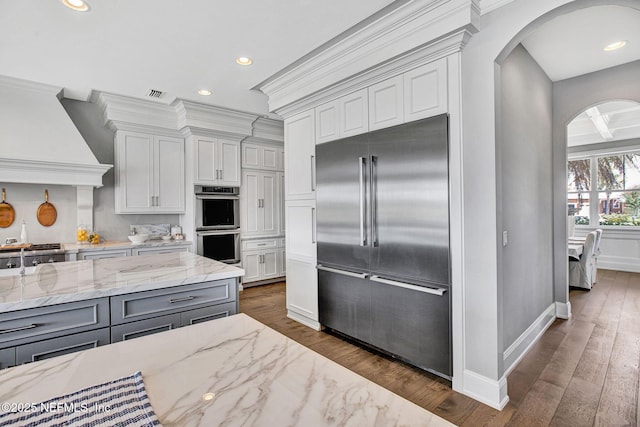 532 Atlantic Beach Ct, Atlantic Beach, FL 32233 - kitchen with appliances with stainless steel finishes, arched walkways, gray cabinets, dark wood-style floors, and recessed lighting