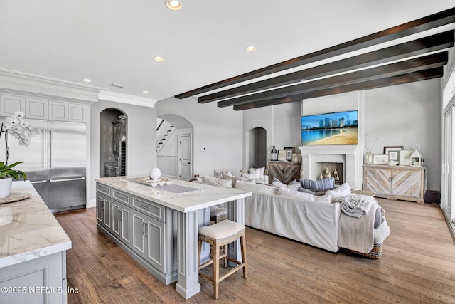 532 Atlantic Beach Ct, Atlantic Beach, FL 32233 - kitchen featuring arched walkways, gray cabinetry, recessed lighting, light stone counters, and dark wood-style flooring