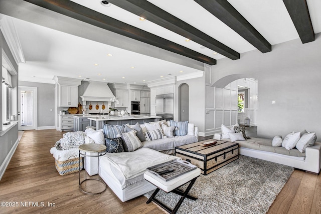 532 Atlantic Beach Ct, Atlantic Beach, FL 32233 - living room with arched walkways, dark wood-type flooring, ornamental molding, recessed lighting, and beamed ceiling