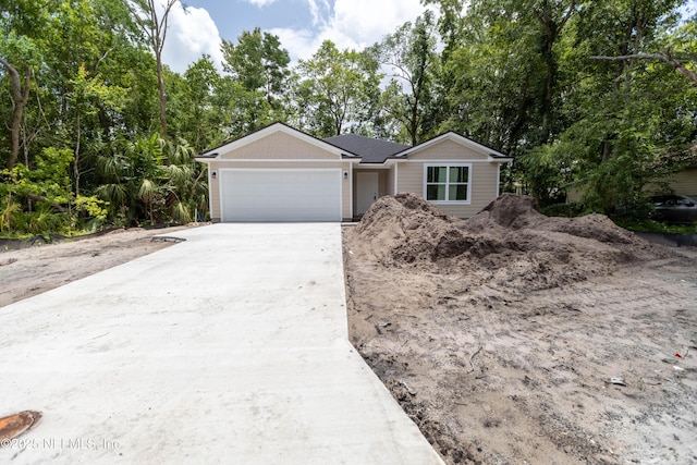 863 W 5th St, Saint Augustine, FL 32084 - view of front of property featuring an attached garage, driveway, and view of wooded area