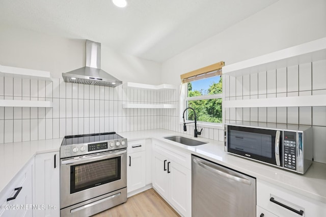 2619 Montreal St, Jacksonville, FL 32233 - kitchen featuring open shelves, wall chimney exhaust hood, stainless steel appliances, and white cabinets