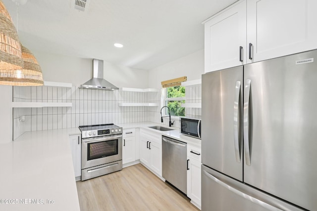 2619 Montreal St, Jacksonville, FL 32233 - kitchen with stainless steel appliances, open shelves, wall chimney exhaust hood, light countertops, and backsplash