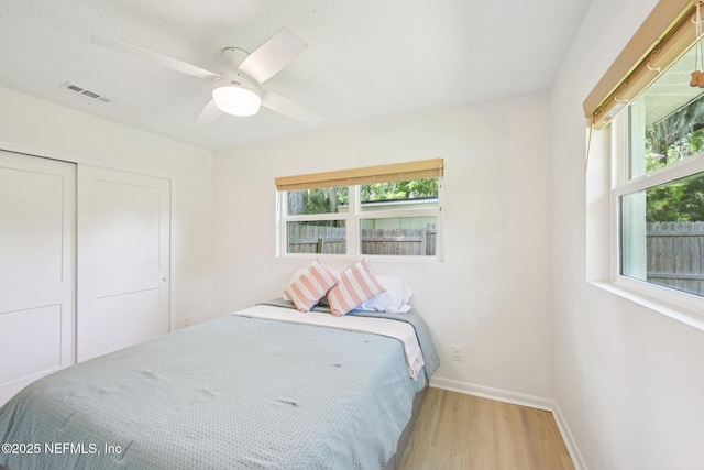 2619 Montreal St, Jacksonville, FL 32233 - bedroom featuring wood finished floors, a closet, ceiling fan, and a textured ceiling