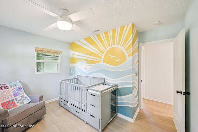 2619 Montreal St, Jacksonville, FL 32233 - bedroom featuring wood finished floors, a textured ceiling, and a ceiling fan
