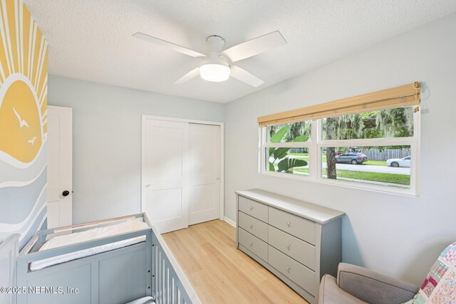 2619 Montreal St, Jacksonville, FL 32233 - bedroom featuring light wood finished floors, a closet, a textured ceiling, and a ceiling fan