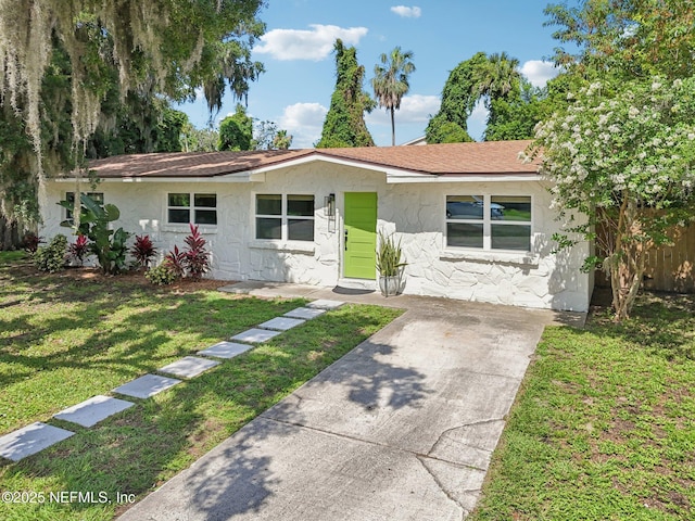 2619 Montreal St, Jacksonville, FL 32233 - view of front facade with stucco siding, stone siding, a shingled roof, and concrete driveway