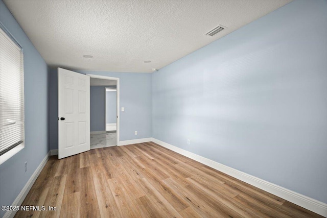 361 Mercury Dr, Orange Park, FL 32073 - unfurnished bedroom with a textured ceiling and light wood finished floors