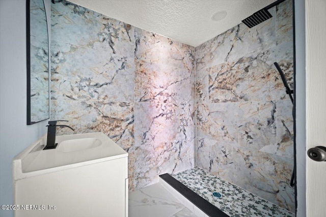 361 Mercury Dr, Orange Park, FL 32073 - bathroom with a textured ceiling, tiled shower, vanity, and marble finish flooring