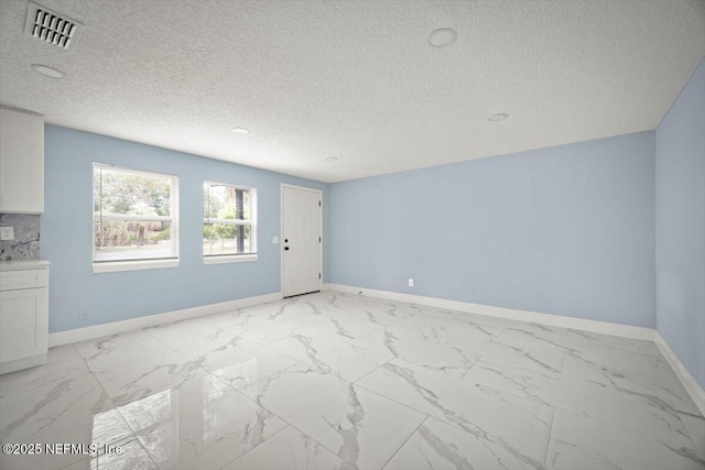 361 Mercury Dr, Orange Park, FL 32073 - unfurnished living room with light marble finish floors and a textured ceiling