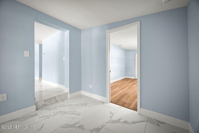 361 Mercury Dr, Orange Park, FL 32073 - empty room with marble look tile flooring and a textured ceiling