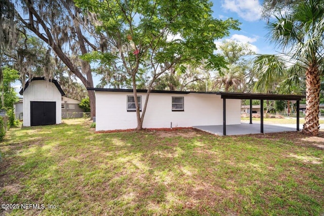 361 Mercury Dr, Orange Park, FL 32073 - rear view of house with a patio area, a lawn, and a storage shed