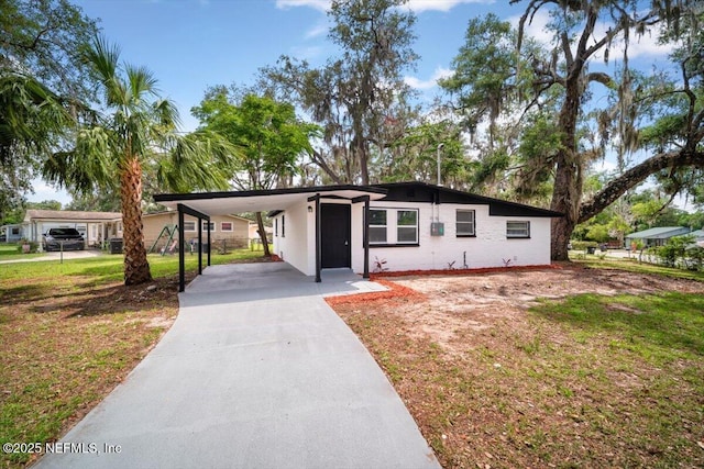 361 Mercury Dr, Orange Park, FL 32073 - view of front of house with a carport, concrete driveway, and a front yard