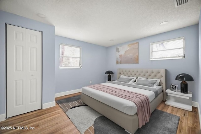 361 Mercury Dr, Orange Park, FL 32073 - bedroom with wood finished floors, a textured ceiling, and a closet
