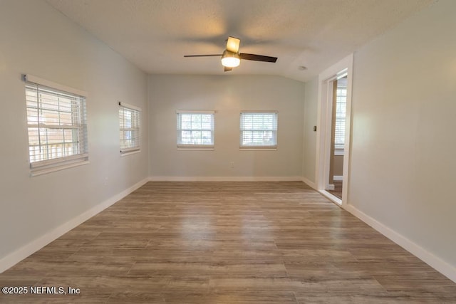 1514 Thomas St, Green Cove Springs, FL 32043 - unfurnished room with a ceiling fan, wood finished floors, vaulted ceiling, a textured ceiling, and baseboards