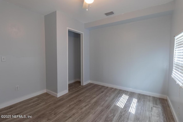 1514 Thomas St, Green Cove Springs, FL 32043 - empty room featuring healthy amount of natural light, wood finished floors, baseboards, and ceiling fan