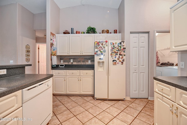 10121 SW 61st Terrace Rd, Ocala, FL 34476 - kitchen with white appliances, washing machine and dryer, dark countertops, light tile patterned floors, and tasteful backsplash