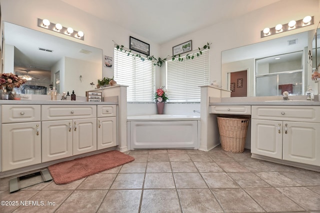 10121 SW 61st Terrace Rd, Ocala, FL 34476 - bathroom featuring a stall shower, a bath, and two vanities