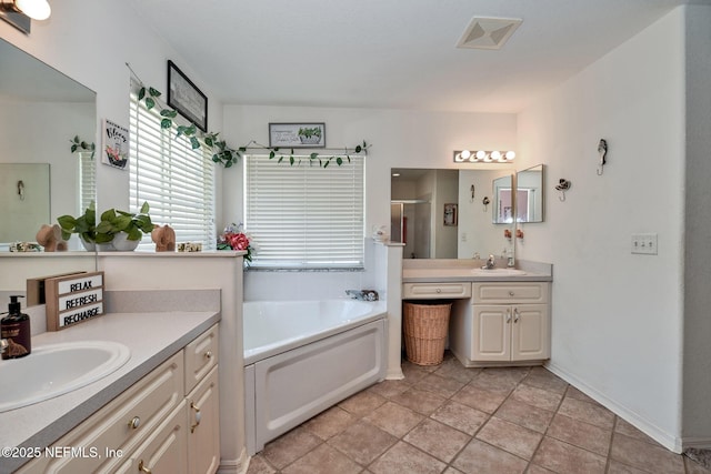 10121 SW 61st Terrace Rd, Ocala, FL 34476 - bathroom featuring a stall shower, a garden tub, and two vanities