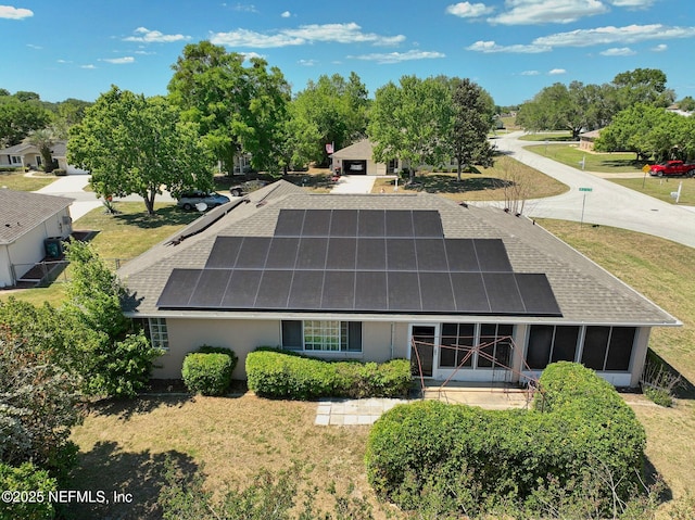 10121 SW 61st Terrace Rd, Ocala, FL 34476 - back of house with a shingled roof and solar panels