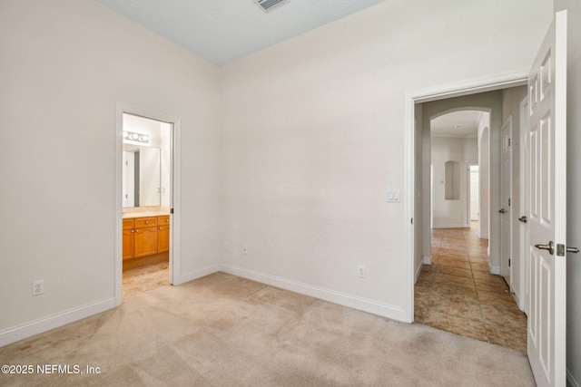3975 Royal Pines Dr, Orange Park, FL 32065 - unfurnished bedroom featuring arched walkways, light colored carpet, and ensuite bath