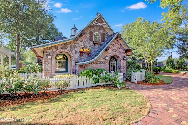 3975 Royal Pines Dr, Orange Park, FL 32065 - view of front of house featuring stone siding, a fenced front yard, and brick siding