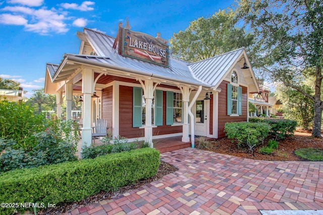 3975 Royal Pines Dr, Orange Park, FL 32065 - view of front of house with a porch, a standing seam roof, and a metal roof