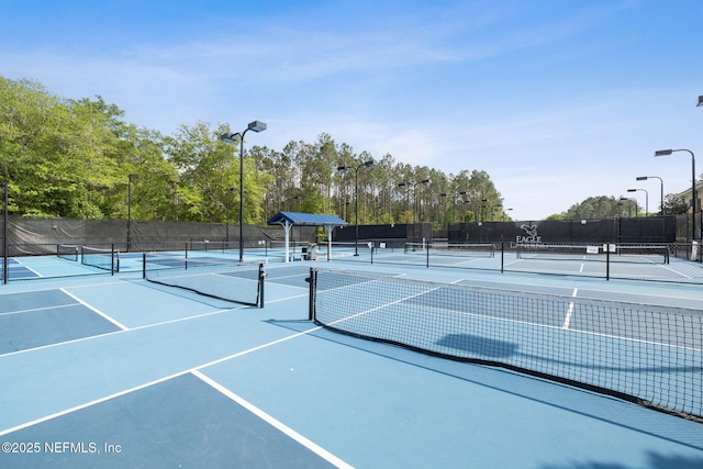 3975 Royal Pines Dr, Orange Park, FL 32065 - view of tennis court with view of wooded area