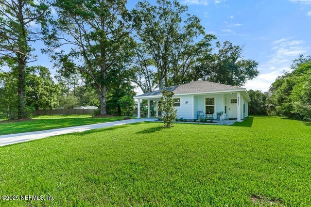 6217 Lobelia St, Jacksonville, FL 32209 - view of front facade featuring driveway, an attached carport, and a porch