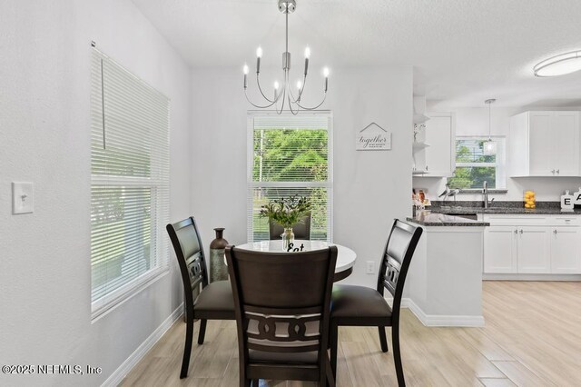 6217 Lobelia St, Jacksonville, FL 32209 - dining area with light wood finished floors and a chandelier