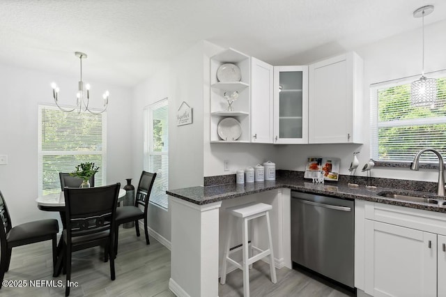 6217 Lobelia St, Jacksonville, FL 32209 - kitchen featuring dishwasher, a chandelier, white cabinetry, open shelves, and dark stone countertops