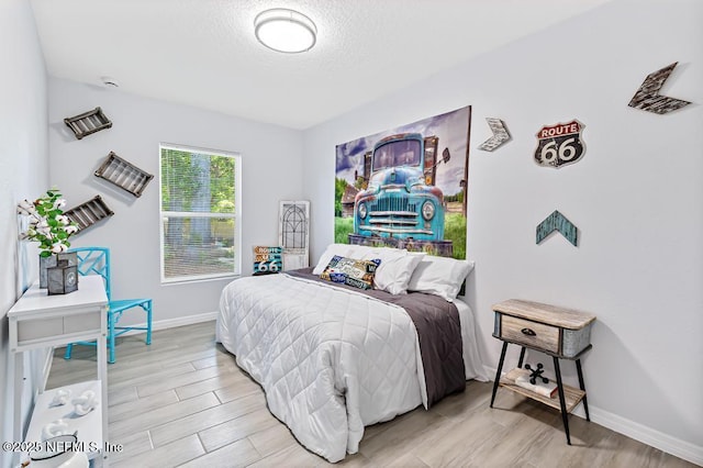 6217 Lobelia St, Jacksonville, FL 32209 - bedroom with wood finished floors and a textured ceiling