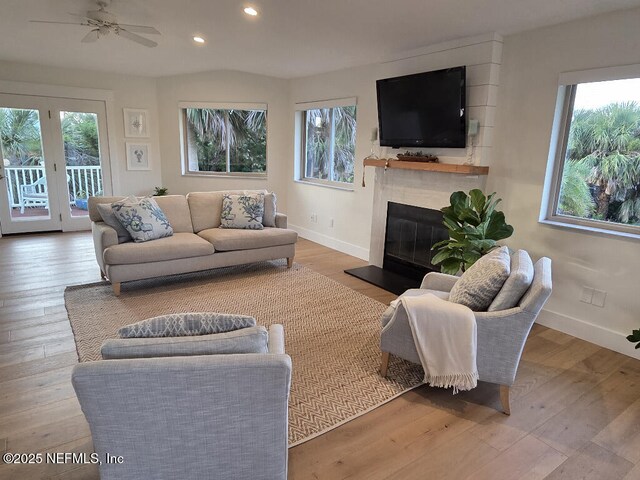 7 Sabor De Sal Rd, Saint Augustine, FL 32080 - living area featuring recessed lighting, plenty of natural light, wood finished floors, a glass covered fireplace, and a ceiling fan