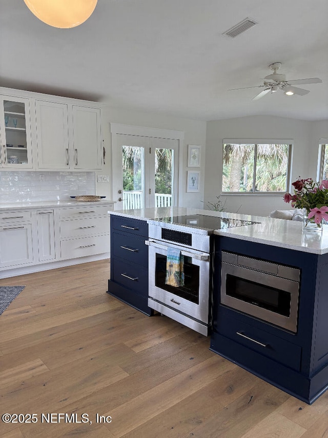 7 Sabor De Sal Rd, Saint Augustine, FL 32080 - kitchen with appliances with stainless steel finishes, white cabinetry, and light wood-style flooring