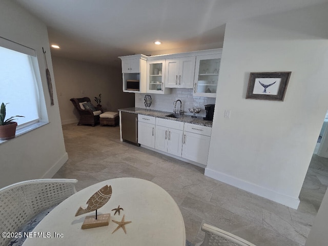 7 Sabor De Sal Rd, Saint Augustine, FL 32080 - kitchen featuring glass insert cabinets, white cabinets, tasteful backsplash, light stone counters, and recessed lighting
