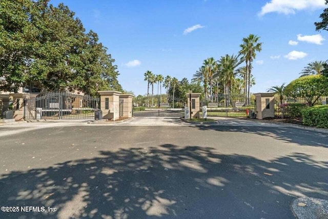 10961 Burnt Mill Rd Unit 917, Jacksonville, FL 32256 - view of asphalt road featuring a gate, a gated entry, and curbs