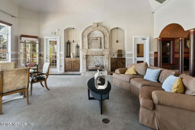 10961 Burnt Mill Rd Unit 917, Jacksonville, FL 32256 - carpeted living room featuring a high ceiling and a fireplace