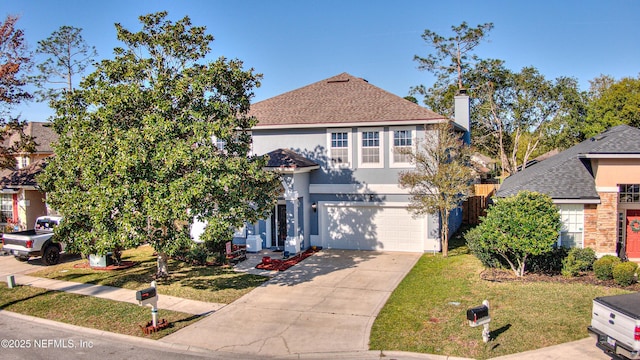 2032 Trailing Pines Way, Fleming Island, FL 32003 - traditional home featuring stucco siding, driveway, a front yard, and a garage
