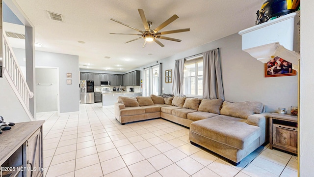 2032 Trailing Pines Way, Fleming Island, FL 32003 - living area with a ceiling fan, light tile patterned floors, and stairway
