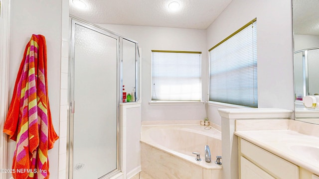 2032 Trailing Pines Way, Fleming Island, FL 32003 - bathroom with a stall shower, vanity, a textured ceiling, and a bath