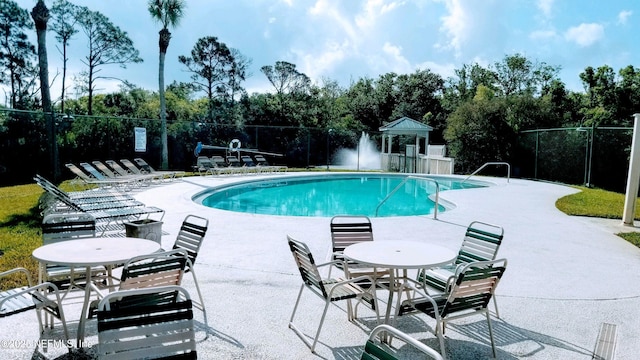 1535 Summer Sands Dr, Neptune Beach, FL 32266 - community pool with a patio area and view of wooded area
