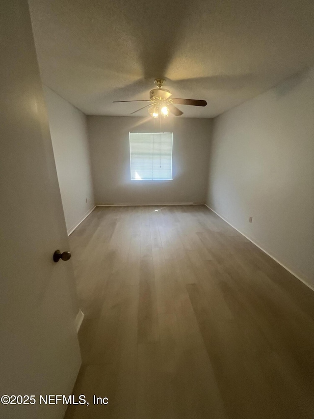 1535 Summer Sands Dr, Neptune Beach, FL 32266 - empty room with a ceiling fan, wood finished floors, and a textured ceiling