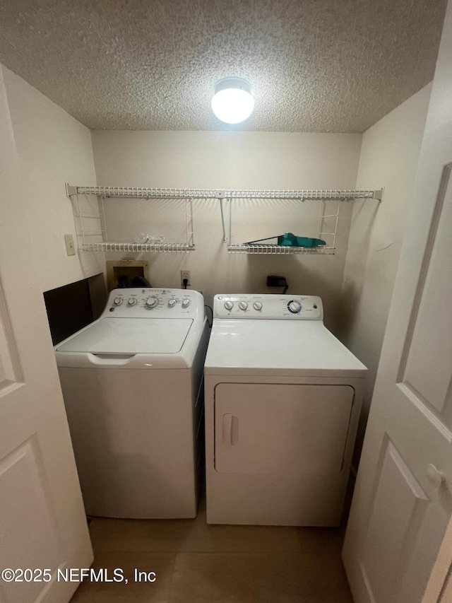 1535 Summer Sands Dr, Neptune Beach, FL 32266 - laundry area featuring washing machine and dryer and a textured ceiling