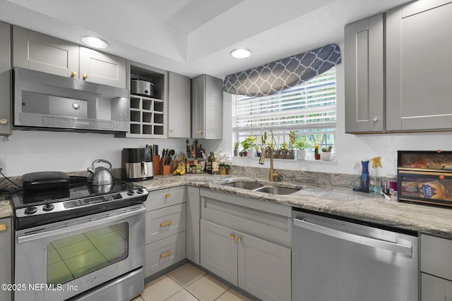 9901 Regency Square Blvd Unit 90, Jacksonville, FL 32225 - kitchen featuring appliances with stainless steel finishes, gray cabinets, a sink, light stone counters, and light tile patterned floors