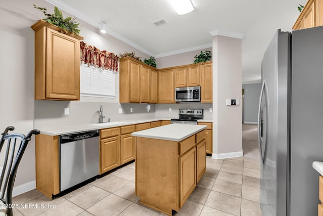 11582 Wynnfield Lakes Cir, Jacksonville, FL 32246 - kitchen with appliances with stainless steel finishes, light countertops, a kitchen island, crown molding, and light tile patterned floors