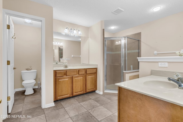 11582 Wynnfield Lakes Cir, Jacksonville, FL 32246 - full bathroom with two vanities, a stall shower, and a textured ceiling